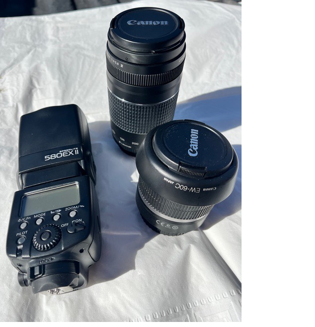 A camera and lens on a white surface
AI-generated content may be incorrect.